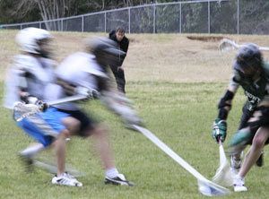 Klahowya boys lacrosse coach Rob Hawley watches intently from the sideline Thursday at Silverdale Elementary as his team practices.