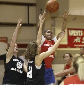 Oly’s Shawntell Bradford jumps above CK’s Katie Lintz to pass the ball to an open teammate during the West Sound All-Star Games.