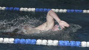 Central Kitsap senior swimmer Kyle Bonnell completes his leg of the Cougars 200-yard freestyle relay which CK won in a time of 1 minute