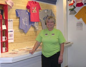 Carleen Rackley stands in front of a display inside T-Shirt Factory in Kitsap Mall. Carleen and her husband