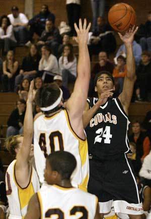 Central Kitsap post Caleb Brown tries to stop Gig Harbors Austin Seferian-Jenkins in the opening minutes of the Tides 83-78 overtime win. Brown was called for a foul on the play.