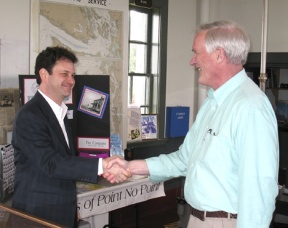Jeff Gales of the U.S. Lighthouse Society shakes hands with Kitsap County Commissioner Steve Bauer inside Point No Point Lighthouse after signing the lease.