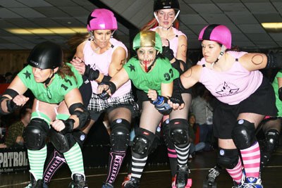 Lolli Von Perkipops (far left) and A. Cup Killer (center) get their block on in Slaughter County's first official bout of 2008. SCRV's Death Rattle Rollers face off against league rivals the Terrormedixxx Jan. 25 at Skateland