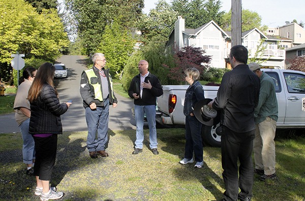 Public Works officials and members of the Suquamish Citizens Advisory Committee meet at the head of a beach path on April 18. The path was closed by the county