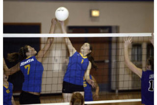 BHS’ Kayla Rose (7) taps a ball over the net during a match last season. Rose is one of two Lady Knights to receive honorable mention on the 2008 AKC Volleyball Team