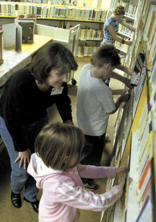 Students are shown helping shelve books at Burley-Glenwood Elementary School