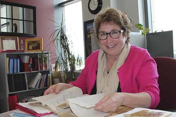 Renee Overath thumbs through historic extension records.