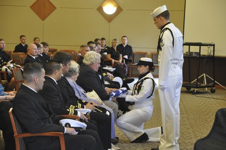 An American flag is presented to Richard Goodwin