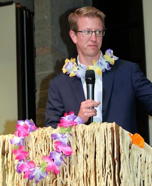 Rep. Derek Kilmer  talks at the luau-themed Chamber luncheon.