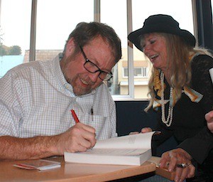Author Daniel James Brown signs a copy of “The Boys in the Boat” for Sherry Barnhart. More than 100 people attended Brown’s presentation Friday afternoon at the Port Orchard Public Library.