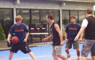 Sports writer Wesley Remmer (left) and staff writer Steven DeDual in “Hoosier Daddies” shirts play against the Kitsap Mall team in the third annual 3-on-3 Silverdale Shoot-Out at the Silverdale Beach Hotel Saturday.