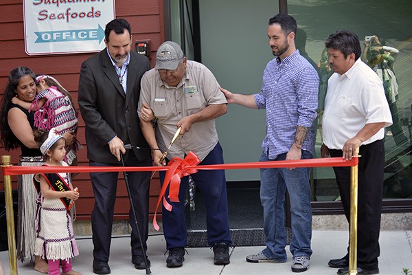 Suquamish elder Manuel “Cohomo” Purcell cuts the ribbon to officially open the Suquamish Seafoods plant
