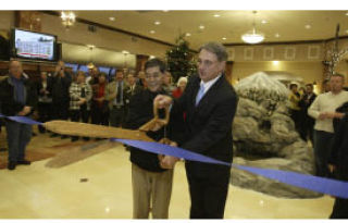 Bremerton Mayor Cary Bozeman (right) and Comfort Inn & Suites owner Bob Parks cut the ceremonial ribbon Wednesday at the new hotel on Kitsap Way.