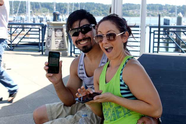 Allen Hewey and Katie Weatherwax catch Pokémon at the Bremerton marina.