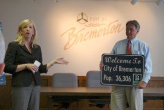 Port of Bremerton Commissioner Cheryl Kincer addressed the crowd celebrating the South Kitsap Industrial Area’s official annexation into the City of Bremerton Wednesday as Bremerton Mayor Cary Bozeman held a new sign that will be placed on State-Route 3 near the airport.