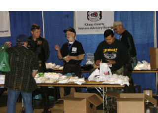 Volunteers from the Kitsap County Veterans Advisory Board talk to a veteran during the spring Stand Down for Veterans and Families at the Kitsap County Fairgrounds President’s Hall May 7.