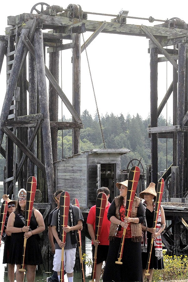 Representatives of the Port Gamble S'Klallam Tribe participate in a blessing ceremony at the old mill site across the bay from Point Julia