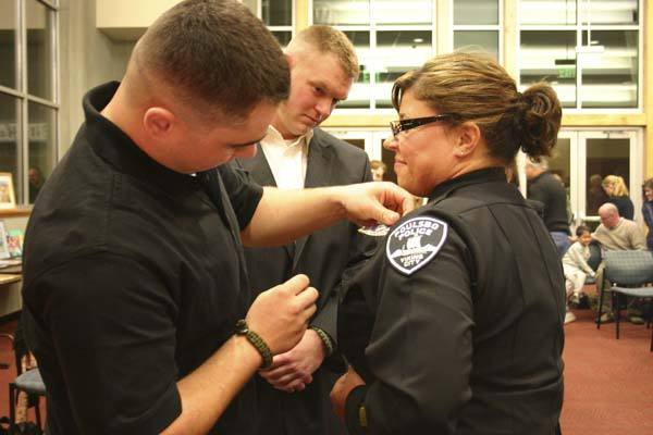 Poulsbo Deputy Police Chief Wendy Davis’ badge is pinned on by her son