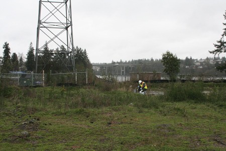 Mike Baxter of Parametrix works on a monitoring well Monday as part of the contamination clean-up and testing that has happened at Evergreen Park since 2006.