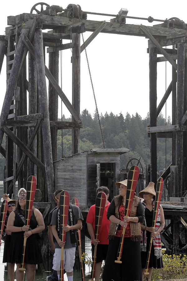 Members of the Port Gamble S’Klallam Canoe Family prepare to offer a dance to invite healing to the land during a blessing ceremony July 23 at the former Port Gamble mill site.