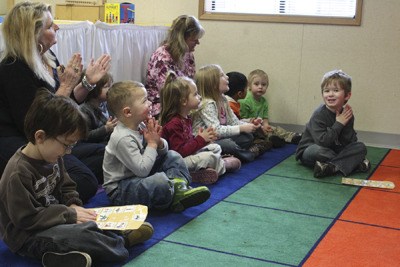 Kids  participate in a finger play activity that Rayna Patison (not pictured) leads at View Ridge and Jessie Kinlow School House in Bremerton last Thursday. The preschool is for all children ages 3 to 5 and currently has open spots.