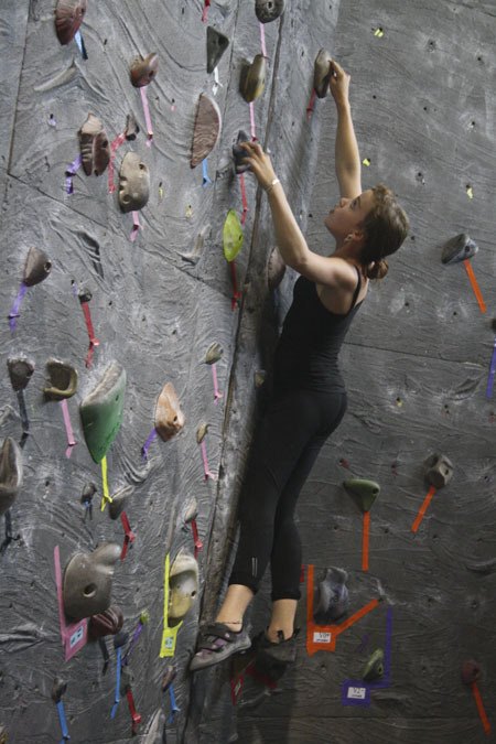 Annalise Rubida 'boulders' the climbing wall at Vertical World Bremerton last Thursday. The 15-year-old is part of Vertical World's youth climbing team.
