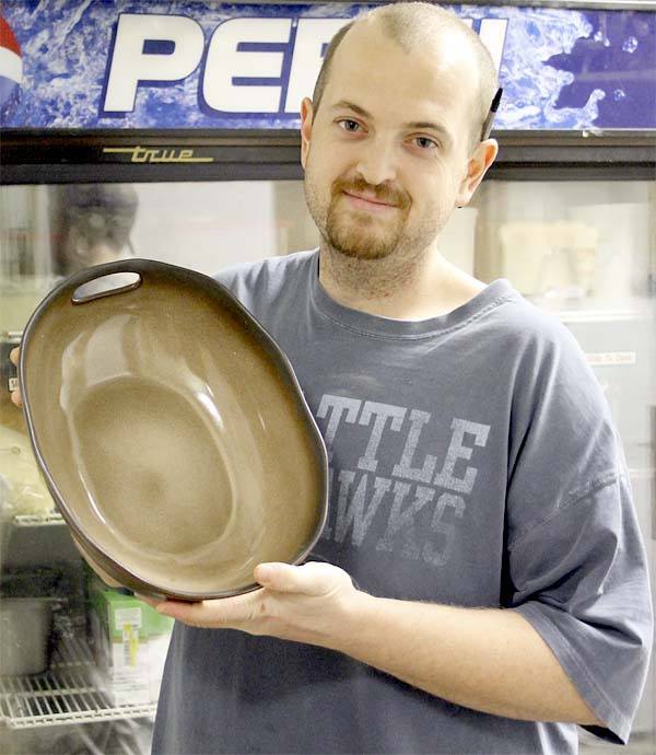 Jon Trunnell of The Flying Pickle Cafe displays the bowl the “Sounder Pounder” is served in.