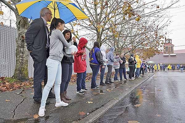 Students at Bremerton High School form a 'Knights Chain' and pass donated food from hand to hand all the way to the Bremerton Foodline food bank.