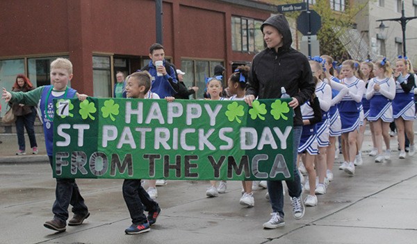 Young members of the YMCA walk along Pacific Avenue in downtown Bremerton during the St. Patrick’s Day Parade March 14.