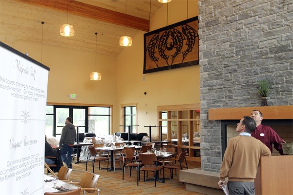 Employees of the new White Horse Golf Club clubhouse admire the interior of the new building March 13 while waiting for guests who attended a preview meal.