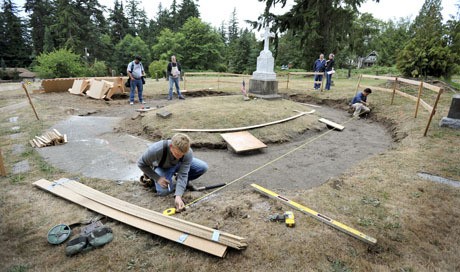 Jared Kurpgeweit with Kurpgeweit Brothers Concrete in Kingston works on new forms at the Chief Sealth gravesite in Suquamish. The site is undergoing renovation before the upcoming Canoe Journeys event.