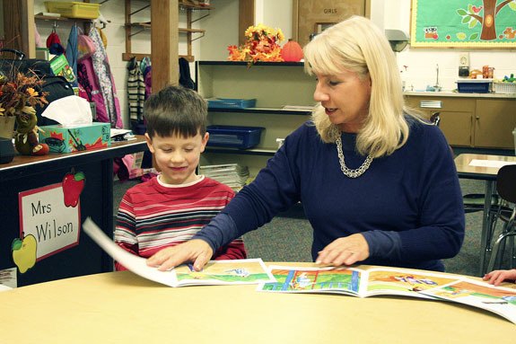 Patti Wilson instructs Trevor Tart on Monday in reading during South Kitsap School District’s first all-day kindergarten program at Olalla Elementary School.