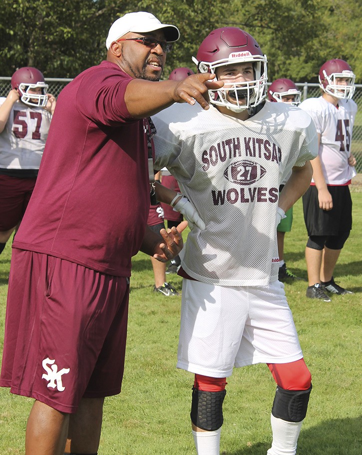 South Kitsap running backs coach Tony Reed gives junior Connor Seaton some pointers during practice Aug. 25.
