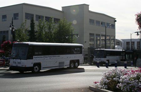 One of the 28 buses recently acquired for the PSNS worker/driver program leaves the shipyard’s Bremerton gate Tuesday.