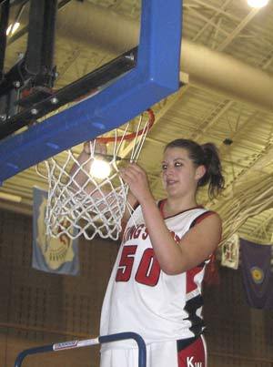 Warrior Hayley Milleson takes her turn cutting part of the net after Kings West won districts.