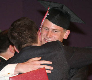Jeffrey Mitchell gets a congratulatory hug after receiving his diploma at the June 6 King’s West graduation. Mitchell was one of 33 students in the King’s West Class of 2008.