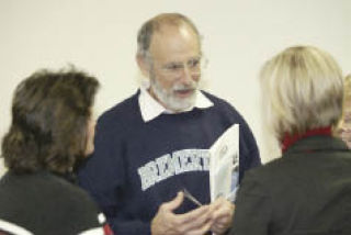 Ron Sher speaks with city officials and community members at the Nov. 30