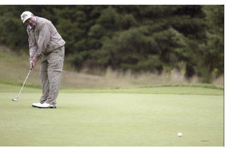 Former South Kitsap football coach Ed Fisher on the putting green last week in the golf tournament that bears his and Benji Olson’s name.