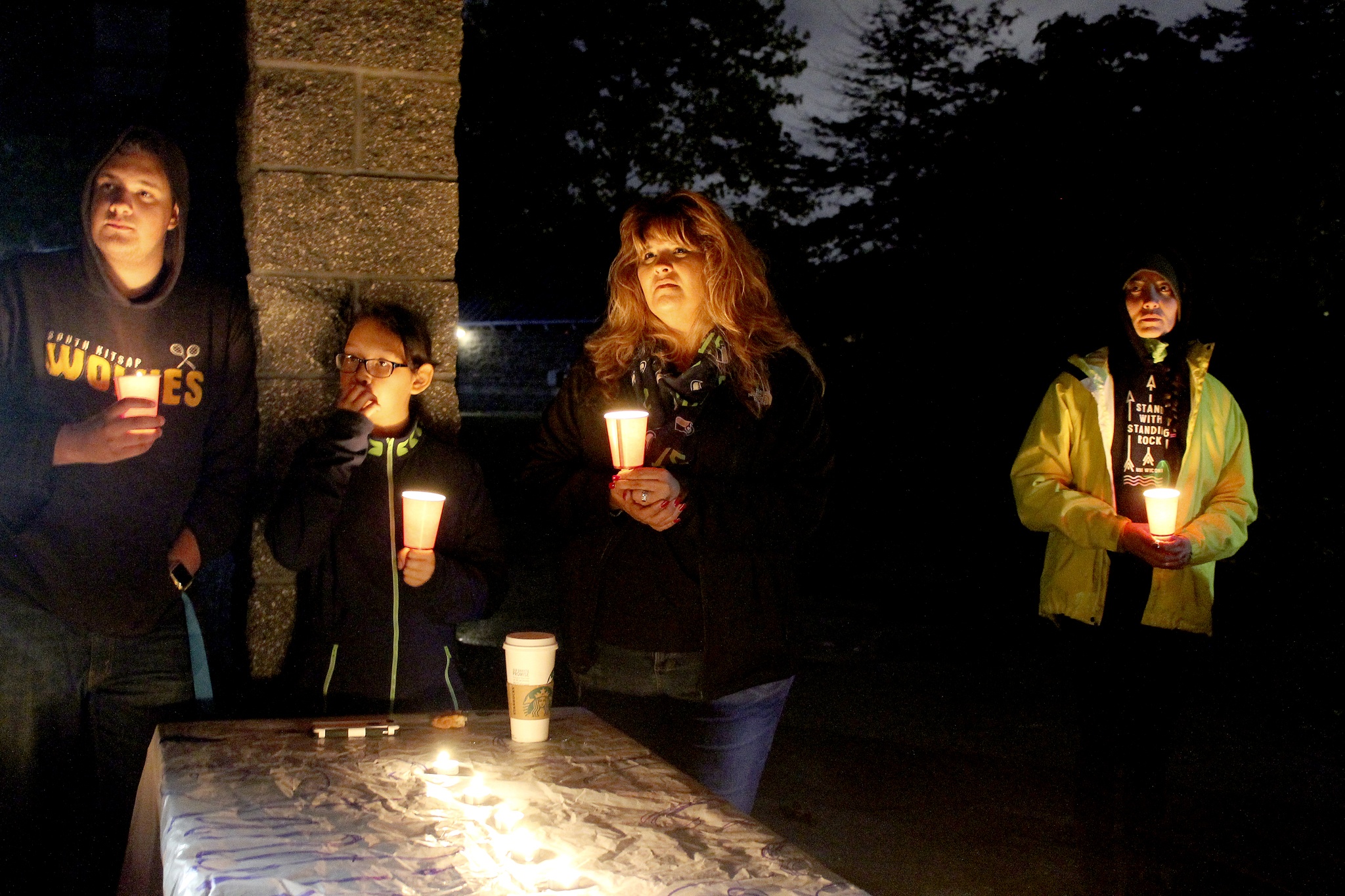 People at the vigil Oct. 30 in support of the Standing Rock protests share their thoughts. Monica Luk, center, is organizing another demonstration for noon to 4 p.m. Nov. 4 at the roundabout in Port Orchard.                                Michelle Beahm / Kitsap News Group