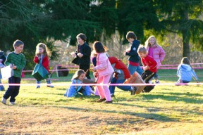 Children swarm one of the designated candy cane hunting areas as part of the city’s second annual candy cane hunt at Raab Park on Sunday.