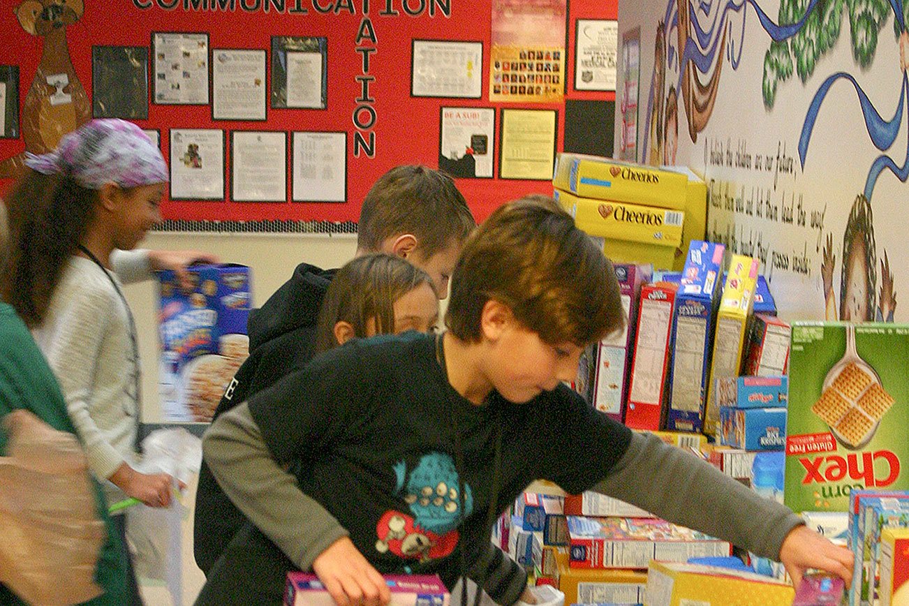 Students add boxes of cereal at the front of View Ridge Elementary. The school-wide goal for the food drive was 500 boxes, which was met Monday, Dec. 12.                                Michelle Beahm / Kitsap News Group