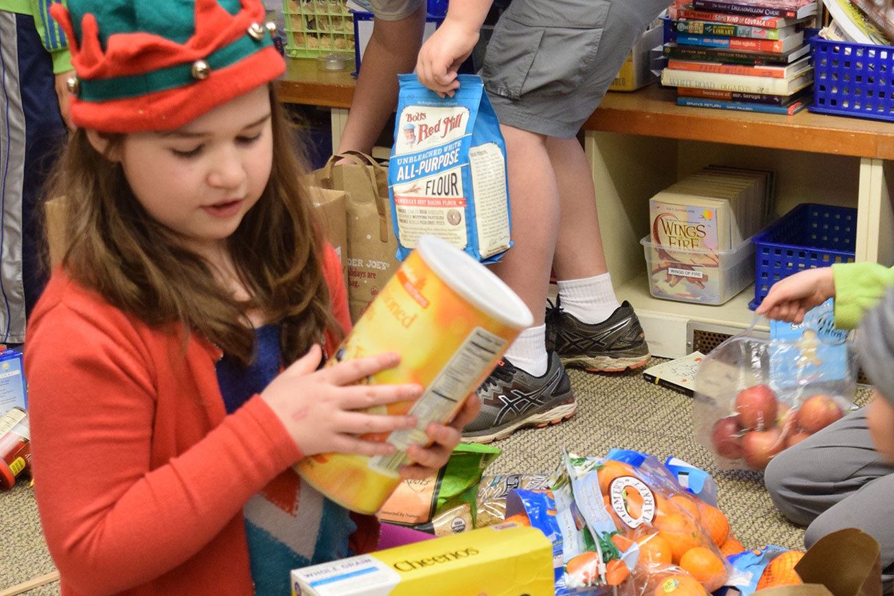 Fifth-graders from The Island School recently delivered 81 pounds of food to North Kitsap Fishline and many boxes of holiday food to Helpline House on Bainbridge Island. (Joan Henderson/Contributed)