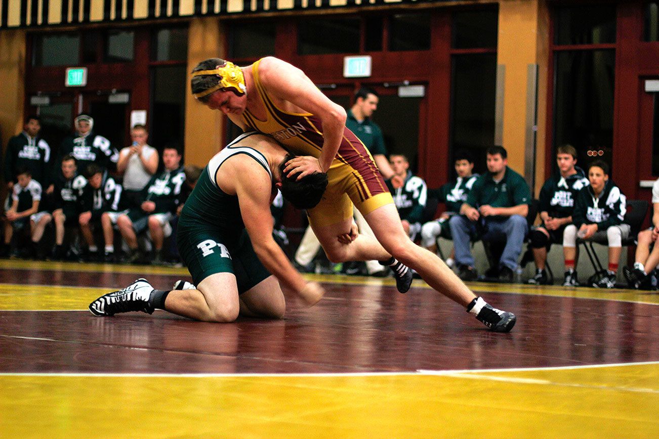 Hunter Collins makes a defensive move during his match against a Port Angeles wrestler Dec. 14. (Sophie Bonomi / Kitsap Daily News)