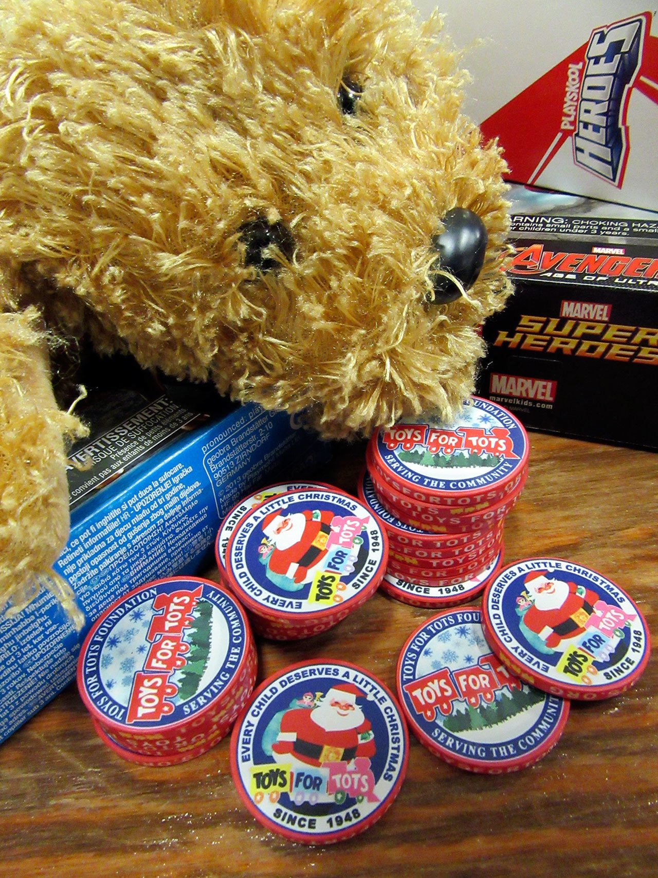 Above left, challenge coins — a military tradition — are presented to Toys for Tots volunteers. Above, Marines in dress uniforms doff their covers and get down to work with volunteers from the Marine Corps League.                                 Terryl Asla/Kitsap News Group