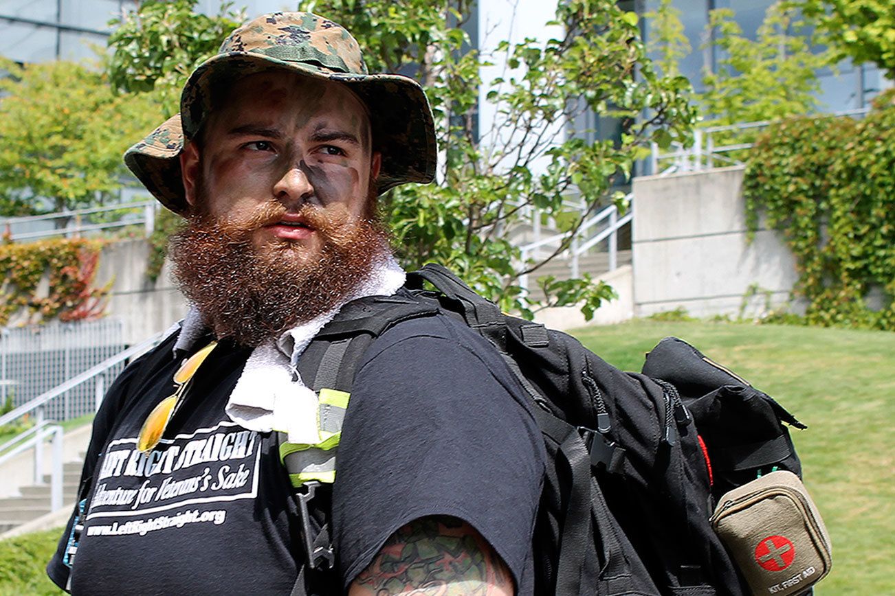Sean Delaire, founder of Left Right Straight, gets ready to head out on a ruck march to raise awareness of the high rate of veteran suicide in July. Recently, Left Right Straight hosted a Buddy Check event, reminding people to reach out to their veteran and active-duty friends to check in and make sure they’re alright. Michelle Beahm / Kitsap News Group