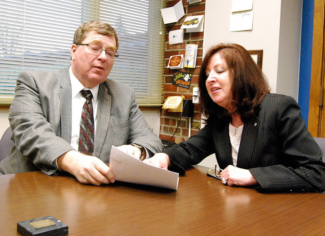 Greg Wall, South Kitsap School District board president, and Tracy Patterson, assistant superintendent of business services, review documents pertaining to the upcoming school bond measure before voters Feb. 14.                                Bob Smith | Kitsap Daily News