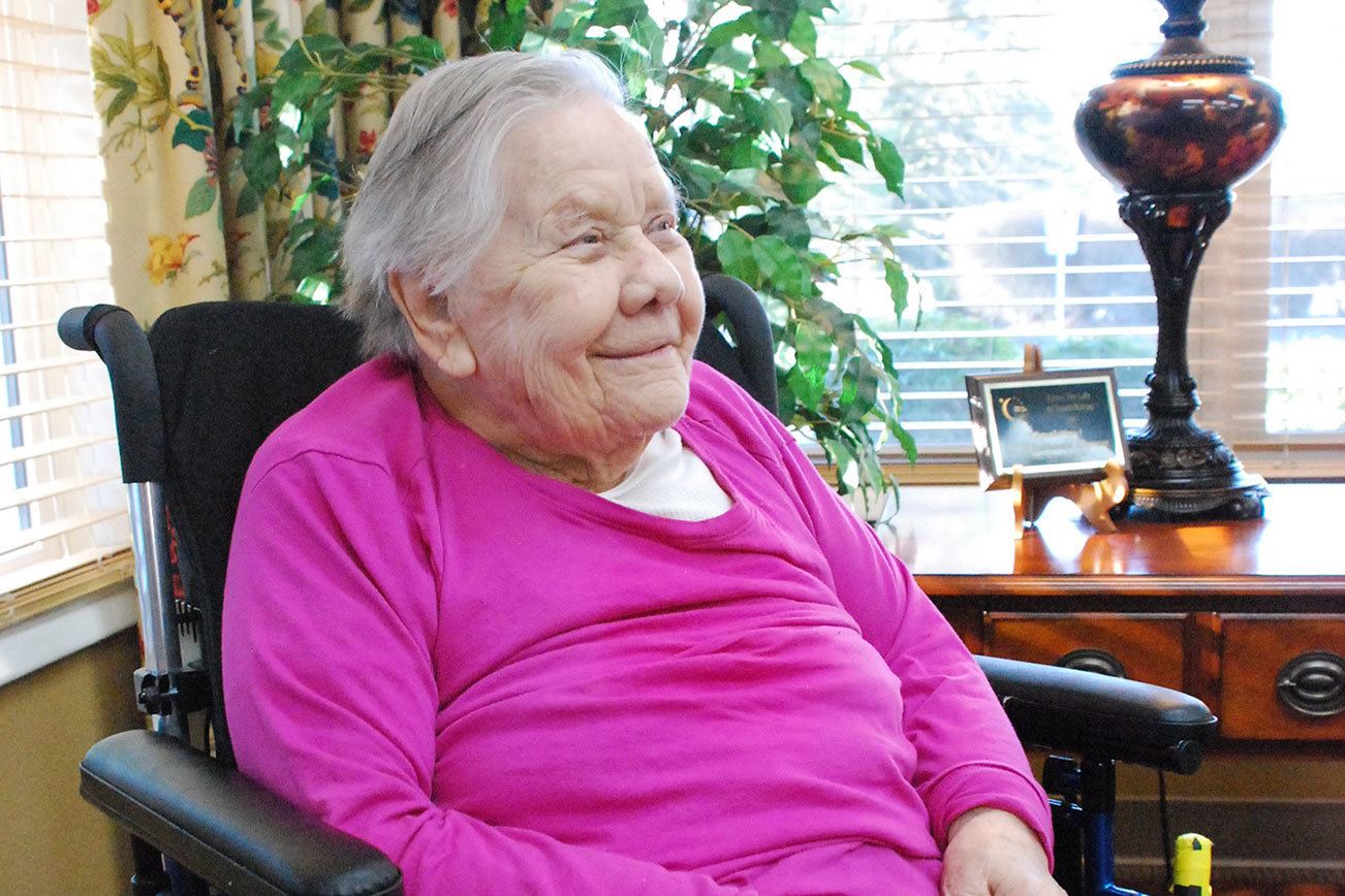 Nonchalant centenarian enjoying life surrounded by loving family