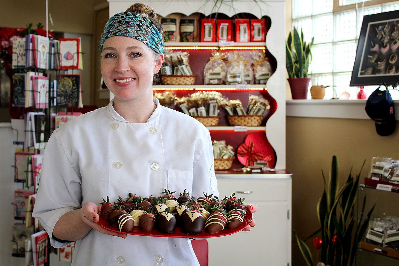 Elizabeth Wing presents hand-dipped strawberries at Amy’s Decadent Chocolate, one of their most popular Valentine’s Day items. Michelle Beahm / Kitsap News Group
