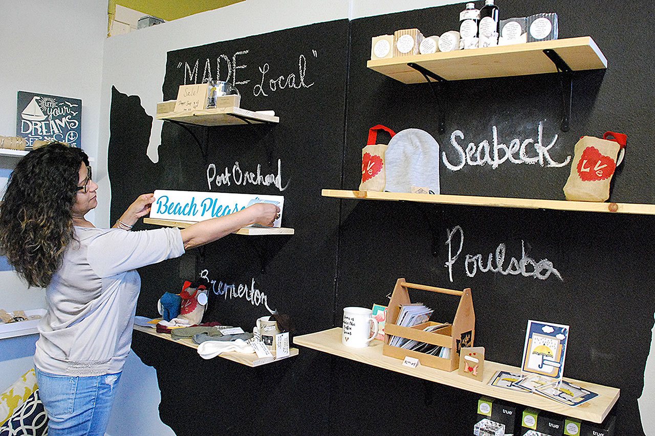 Ramona Karwacki of N9NE & Co. shows a wall devoted to products made by local artisans. Photo credit: Bob Smith | Kitsap Daily News