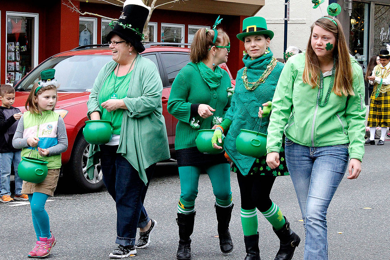 Participants in the 2016 Bremerton St. Patrick’s Day parade pass out gold coins to spectators.                                Michelle Beahm / Kitsap News Group